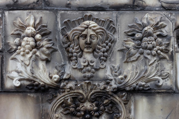 vintage modeling on the wall. woman with flowers and berries. pattern