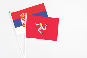 Isle Of Man and Serbia stick flags on white background. High quality fabric, miniature national...