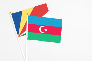 Azerbaijan and Seychelles stick flags on white background. High quality fabric, miniature national flag. Peaceful global concept.White floor for copy space.v