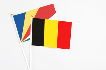 Belgium and Seychelles stick flags on white background. High quality fabric, miniature national flag. Peaceful global concept.White floor for copy space.v