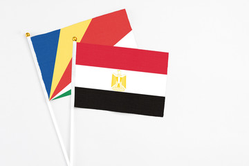 Egypt and Seychelles stick flags on white background. High quality fabric, miniature national flag. Peaceful global concept.White floor for copy space.v