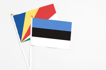 Estonia and Seychelles stick flags on white background. High quality fabric, miniature national flag. Peaceful global concept.White floor for copy space.v