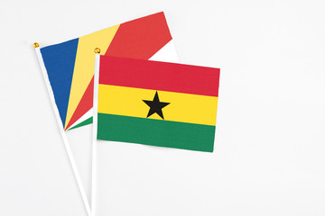 Ghana and Seychelles stick flags on white background. High quality fabric, miniature national flag. Peaceful global concept.White floor for copy space.v