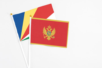 Montenegro and Seychelles stick flags on white background. High quality fabric, miniature national flag. Peaceful global concept.White floor for copy space.v