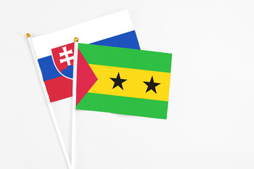 Sao Tome And Principe and Slovakia stick flags on white background. High quality fabric, miniature national flag. Peaceful global concept.White floor for copy space.