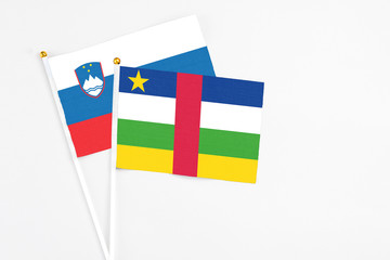 Central African Republic and Slovenia stick flags on white background. High quality fabric, miniature national flag. Peaceful global concept.White floor for copy space.