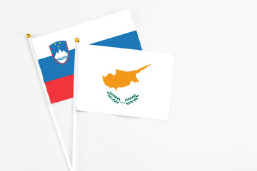 Cyprus and Slovenia stick flags on white background. High quality fabric, miniature national flag. Peaceful global concept.White floor for copy space.