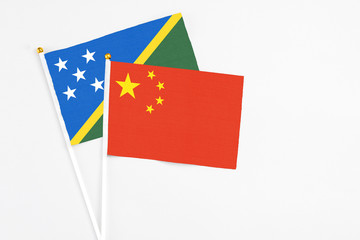 China and Solomon Islands stick flags on white background. High quality fabric, miniature national...