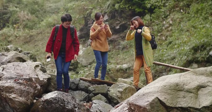 Asian Female friends taking picture outdoor in the mountain people traveling hiking lifestyle in the wild