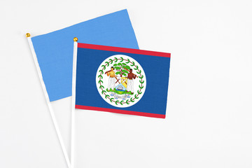 Belize and Somalia stick flags on white background. High quality fabric, miniature national flag. Peaceful global concept.White floor for copy space.