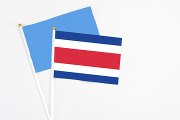 Costa Rica and Somalia stick flags on white background. High quality fabric, miniature national flag. Peaceful global concept.White floor for copy space.