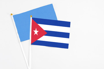 Cuba and Somalia stick flags on white background. High quality fabric, miniature national flag. Peaceful global concept.White floor for copy space.