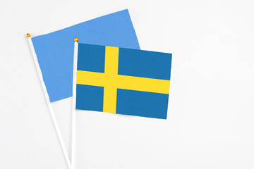 Sweden and Somalia stick flags on white background. High quality fabric, miniature national flag. Peaceful global concept.White floor for copy space.