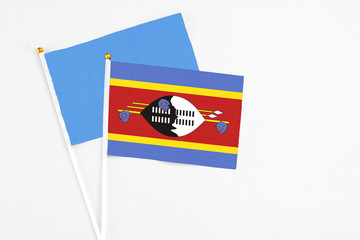 Swaziland and Somalia stick flags on white background. High quality fabric, miniature national flag. Peaceful global concept.White floor for copy space.