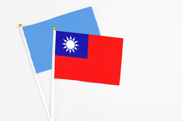 Taiwan and Somalia stick flags on white background. High quality fabric, miniature national flag. Peaceful global concept.White floor for copy space.