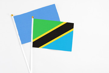Tanzania and Somalia stick flags on white background. High quality fabric, miniature national flag. Peaceful global concept.White floor for copy space.