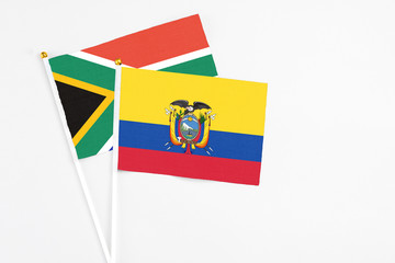 Ecuador and South Africa stick flags on white background. High quality fabric, miniature national flag. Peaceful global concept.White floor for copy space.