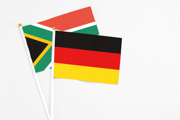 Germany and South Africa stick flags on white background. High quality fabric, miniature national flag. Peaceful global concept.White floor for copy space.
