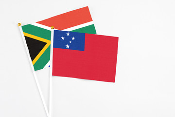 Samoa and South Africa stick flags on white background. High quality fabric, miniature national flag. Peaceful global concept.White floor for copy space.