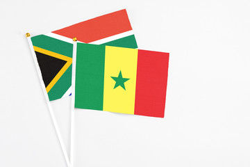Senegal and South Africa stick flags on white background. High quality fabric, miniature national flag. Peaceful global concept.White floor for copy space.