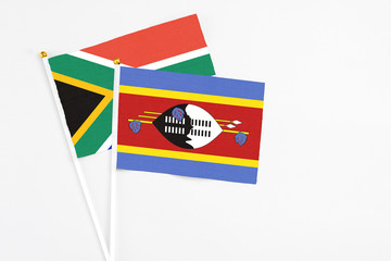 Swaziland and South Africa stick flags on white background. High quality fabric, miniature national flag. Peaceful global concept.White floor for copy space.