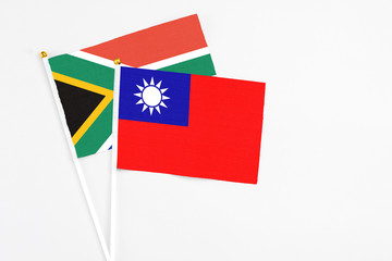 Taiwan and South Africa stick flags on white background. High quality fabric, miniature national flag. Peaceful global concept.White floor for copy space.