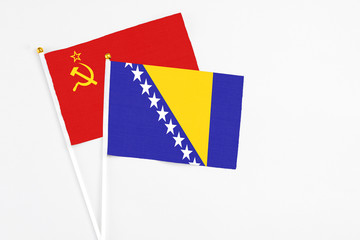 Bosnia Herzegovina and Soviet Union stick flags on white background. High quality fabric, miniature national flag. Peaceful global concept.White floor for copy space.
