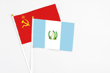 Guatemala and Soviet Union stick flags on white background. High quality fabric, miniature national flag. Peaceful global concept.White floor for copy space.