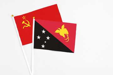 Papua New Guinea and Soviet Union stick flags on white background. High quality fabric, miniature national flag. Peaceful global concept.White floor for copy space.