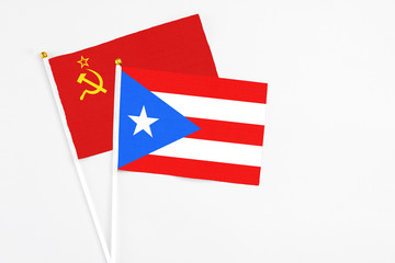 Puerto Rico and Soviet Union stick flags on white background. High quality fabric, miniature national flag. Peaceful global concept.White floor for copy space.