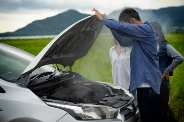The man was shocked after opening the bonnet with smoke from the engine.car breakdown on the road.