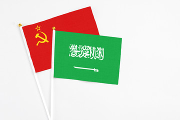 Saudi Arabia and Soviet Union stick flags on white background. High quality fabric, miniature national flag. Peaceful global concept.White floor for copy space.