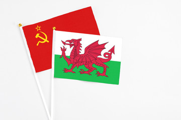 Wales and Soviet Union stick flags on white background. High quality fabric, miniature national flag. Peaceful global concept.White floor for copy space.