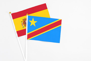 Congo and Spain stick flags on white background. High quality fabric, miniature national flag. Peaceful global concept.White floor for copy space.