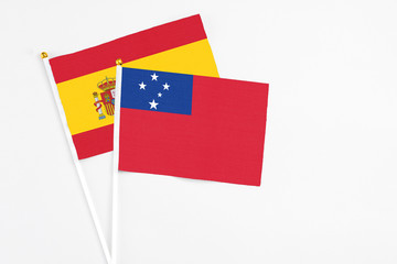 Samoa and Spain stick flags on white background. High quality fabric, miniature national flag. Peaceful global concept.White floor for copy space.