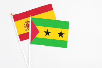 Sao Tome And Principe and Spain stick flags on white background. High quality fabric, miniature national flag. Peaceful global concept.White floor for copy space.
