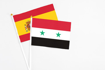 Syria and Spain stick flags on white background. High quality fabric, miniature national flag....