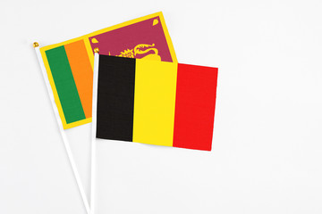 and Sri Lanka stick flags on white background. High quality fabric, miniature national flag. Peaceful global concept.White floor for copy space.