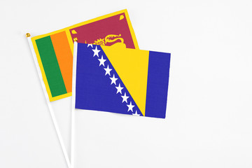 Fototapeta premium and Sri Lanka stick flags on white background. High quality fabric, miniature national flag. Peaceful global concept.White floor for copy space.