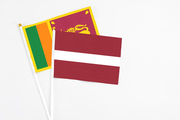 and Sri Lanka stick flags on white background. High quality fabric, miniature national flag. Peaceful global concept.White floor for copy space.