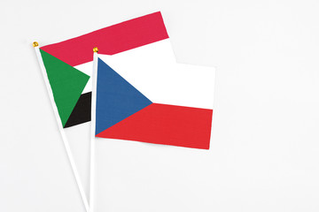 Czech Republic and Sudan stick flags on white background. High quality fabric, miniature national flag. Peaceful global concept.White floor for copy space.