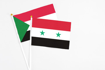 Syria and Sudan stick flags on white background. High quality fabric, miniature national flag....