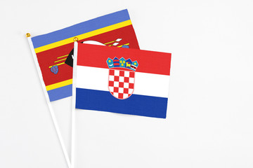 Croatia and Swaziland stick flags on white background. High quality fabric, miniature national...