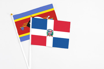 Dominican Republic and Swaziland stick flags on white background. High quality fabric, miniature national flag. Peaceful global concept.White floor for copy space.