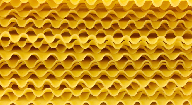 Wavy sheets for lasagna. From durum wheat. Close up. Isolated on white background