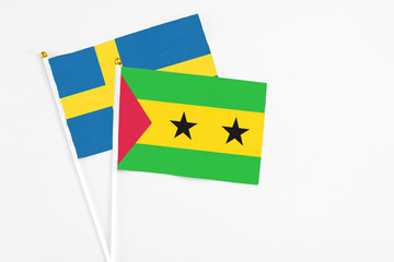 Sao Tome And Principe and Sweden stick flags on white background. High quality fabric, miniature national flag. Peaceful global concept.White floor for copy space.