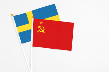 Soviet Union and Sweden stick flags on white background. High quality fabric, miniature national flag. Peaceful global concept.White floor for copy space.
