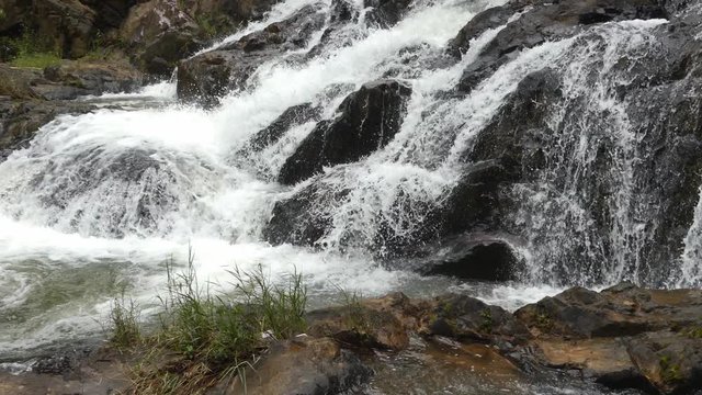 Datanla waterfall in DaLat, Vietnam. Panoramic movement from rright to left. Close view of waterfall and rivier. Waterfall in the forest.