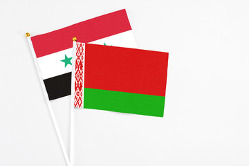 Belarus and Syria stick flags on white background. High quality fabric, miniature national flag....