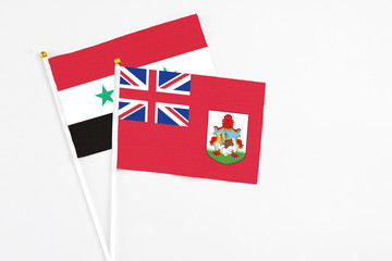 Bermuda and Syria stick flags on white background. High quality fabric, miniature national flag....